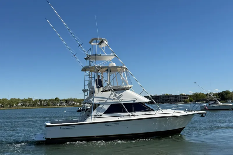 Slide: The Image of 1987 Phoenix 34 SFX Convertible boat cruising on a sunny day. - 5
