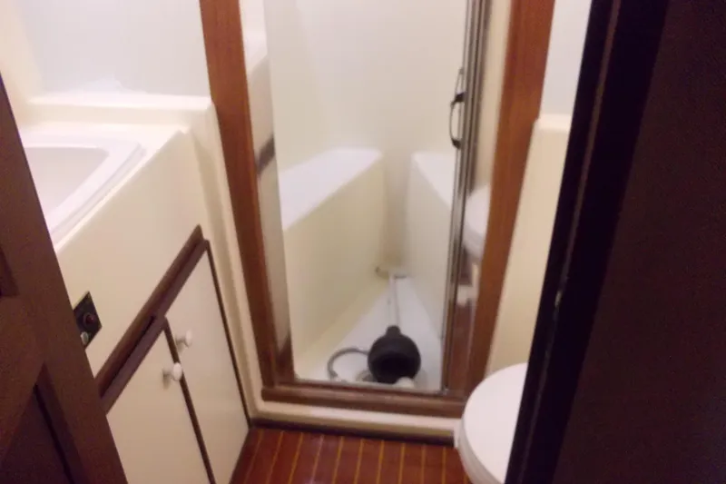 Slide: The Image of Bathroom interior of 1982 Hatteras 46 Convertible yacht with shower and toilet. - 12