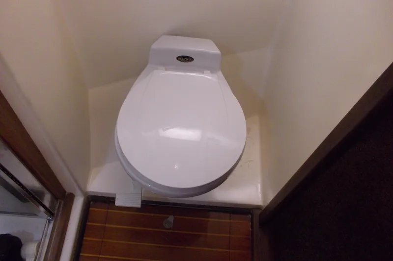 Slide: The Image of Toilet in 1982 Hatteras 46 Convertible yacht bathroom, featuring wooden flooring. - 13