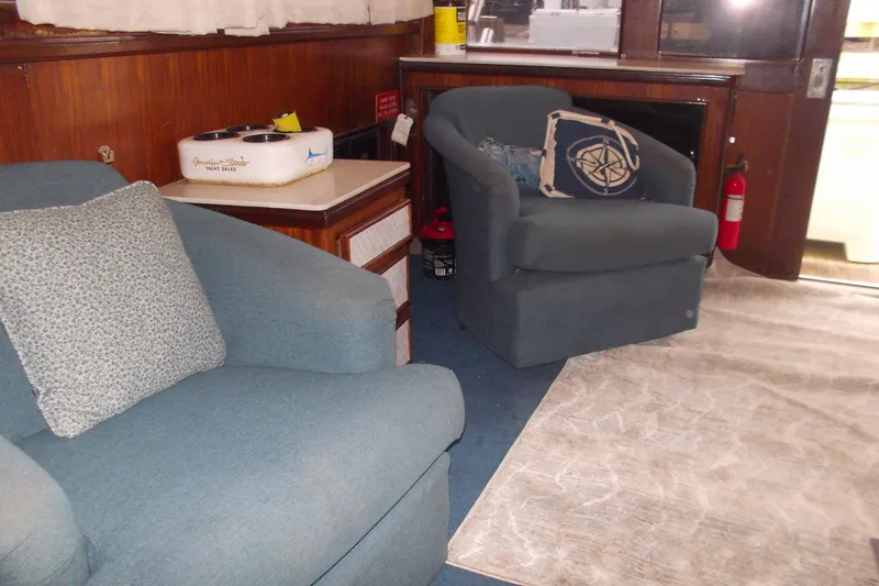 Slide: The Image of Interior of 1982 Hatteras 46 Convertible yacht with blue armchairs and nautical decor. - 14