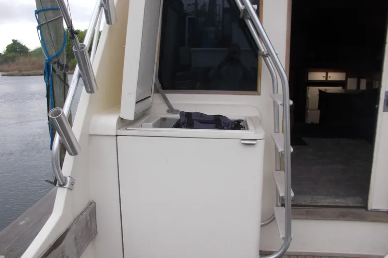 Slide: The Image of 1982 Hatteras 46 Convertible boat deck with storage compartment and railing. - 15