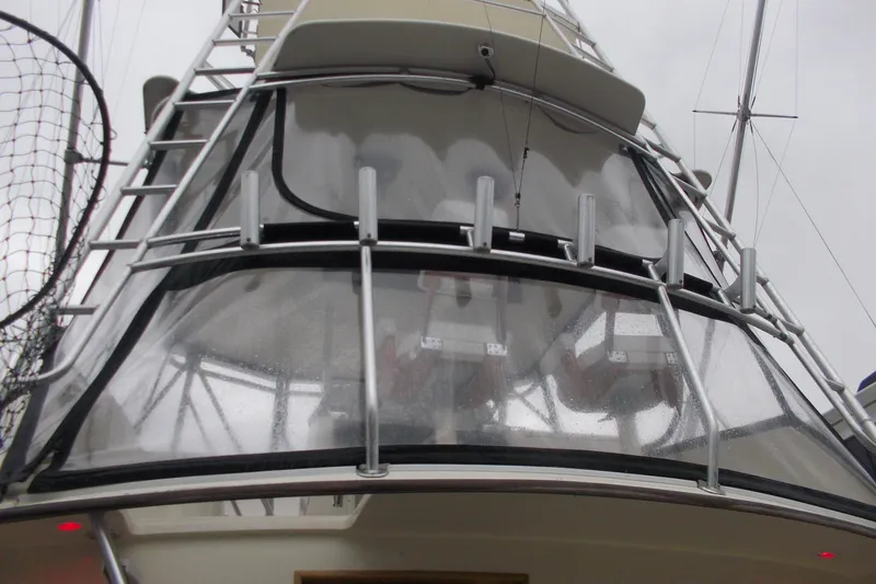 Slide: The Image of 1982 Hatteras 46 Convertible yacht with clear enclosure and ladder, viewed from below. - 17