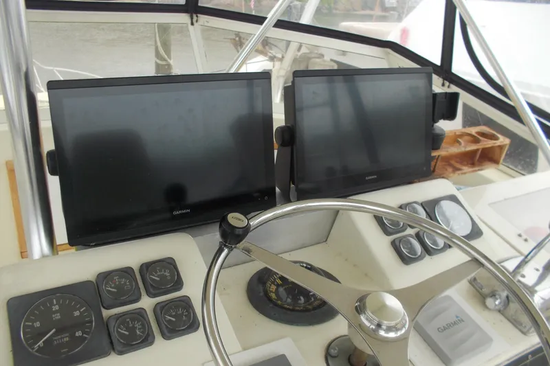 Slide: The Image of Helm of 1982 Hatteras 46 Convertible with Garmin displays and navigation instruments. - 19