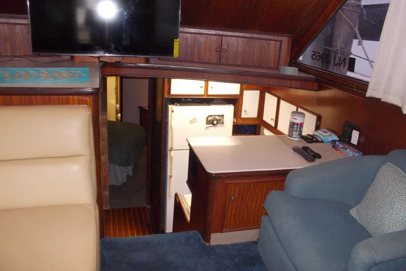 Slide: The Image of Interior of 1982 Hatteras 46 Convertible yacht with cozy seating and kitchenette. - 2