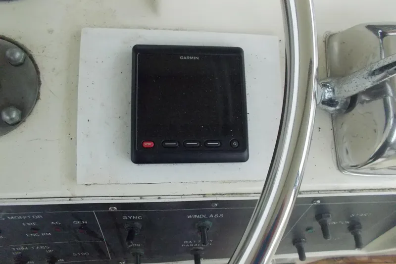 Slide: The Image of Garmin device on 1982 Hatteras 46 Convertible yacht dashboard with steering wheel. - 22