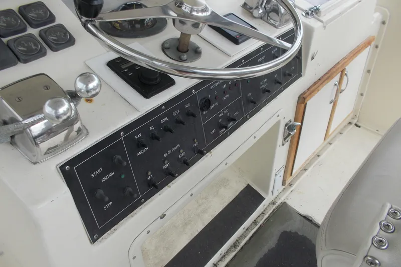 Slide: The Image of Control panel of a 1982 Hatteras 46 Convertible yacht with steering wheel and switches. - 23
