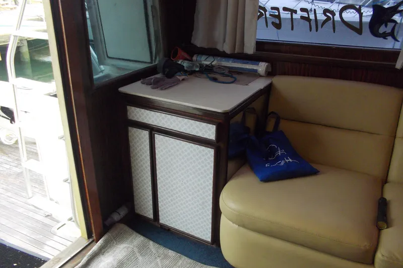 Slide: The Image of Interior of 1982 Hatteras 46 Convertible yacht with seating and storage area. - 4