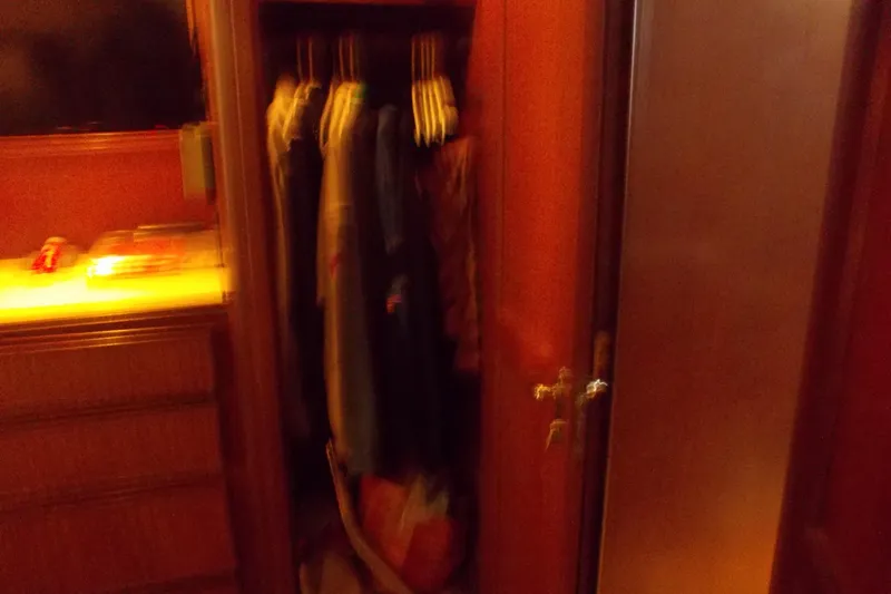 Slide: The Image of Interior of 1982 Hatteras 46 Convertible showing a closet with hanging clothes. - 9