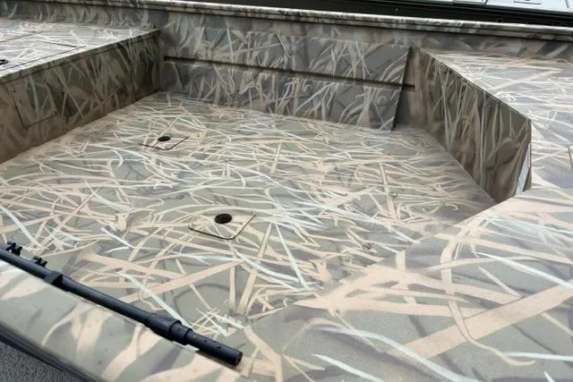 Slide: The Image of 2026 Lowe Roughneck 1660 Deluxe Tiller boat interior with camouflage pattern design. - 6