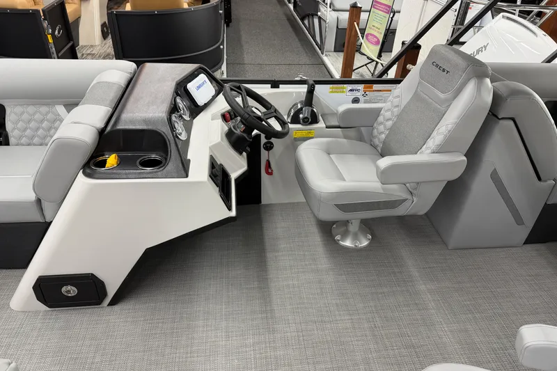 Slide: The Image of 2026 Crest Conquest 210 SLC boat interior with modern helm and comfortable seating. - 6