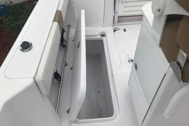 Slide: The Image of 2017 Pro-Line 29 Grand Sport boat interior with open storage compartment. - 11