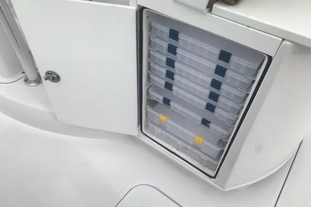 Slide: The Image of Storage compartment with organized tackle boxes on a 2017 Pro-Line 29 Grand Sport boat. - 12