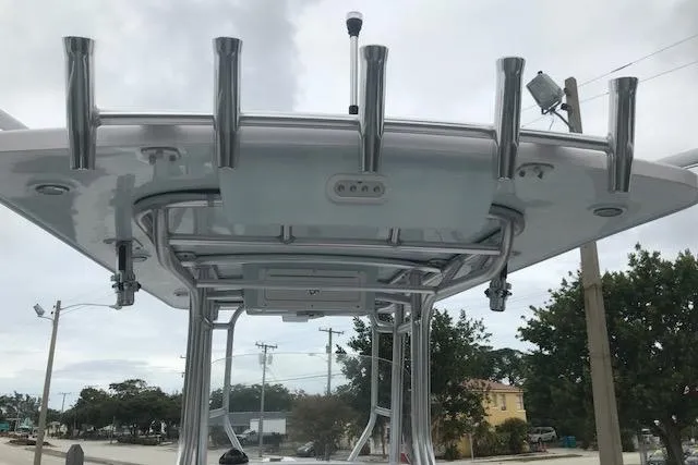 Slide: The Image of 2017 Pro-Line 29 Grand Sport boat with rod holders and T-top structure. - 13