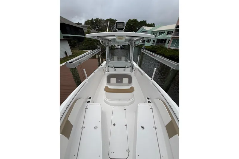 Slide: The Image of 2017 Pro-Line 29 Grand Sport boat docked, showcasing spacious deck and sleek design. - 18