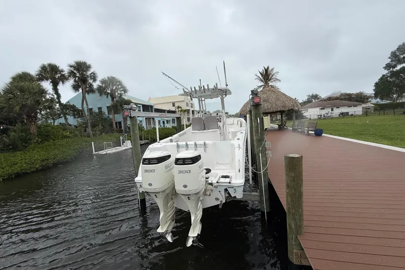 Slide: The Image of 2017 Pro-Line 29 Grand Sport boat docked with twin 300 horsepower engines. - 2