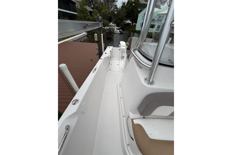 Slide: The Image of 2017 Pro-Line 29 Grand Sport boat docked, showcasing sleek deck and seating area. - 20