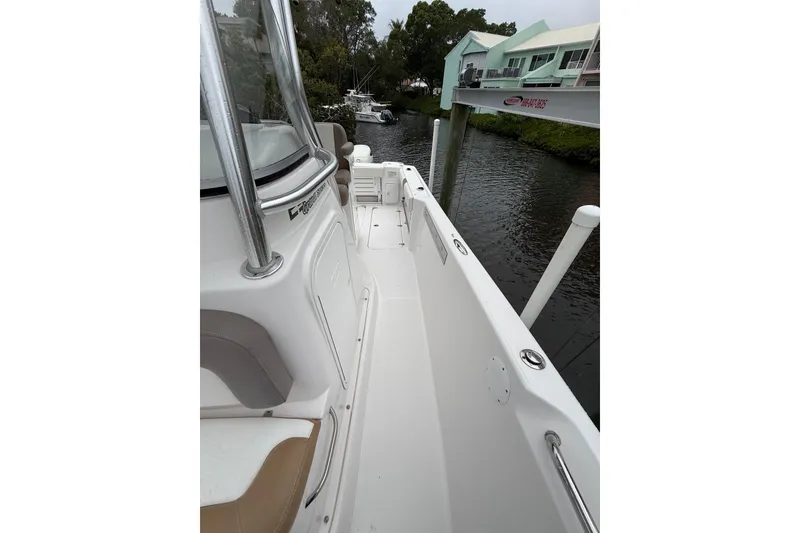Slide: The Image of 2017 Pro-Line 29 Grand Sport boat docked by waterfront homes. - 21