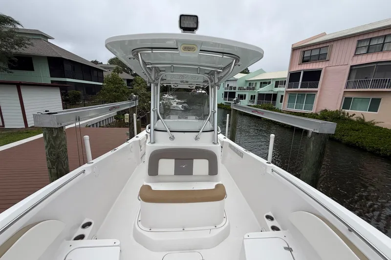 Slide: The Image of 2017 Pro-Line 29 Grand Sport boat docked near colorful waterfront homes. - 23