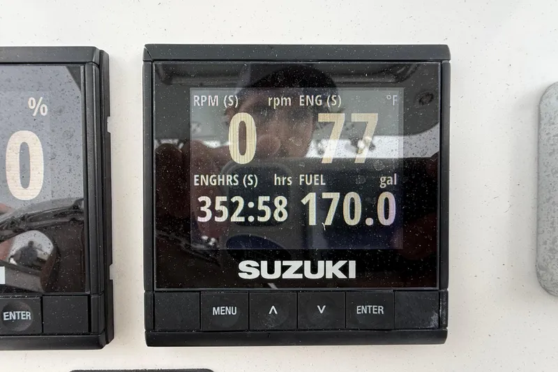 Slide: The Image of Suzuki engine display showing 352.58 hours and 170 gallons on a 2017 Pro-Line 29 Grand Sport. - 26