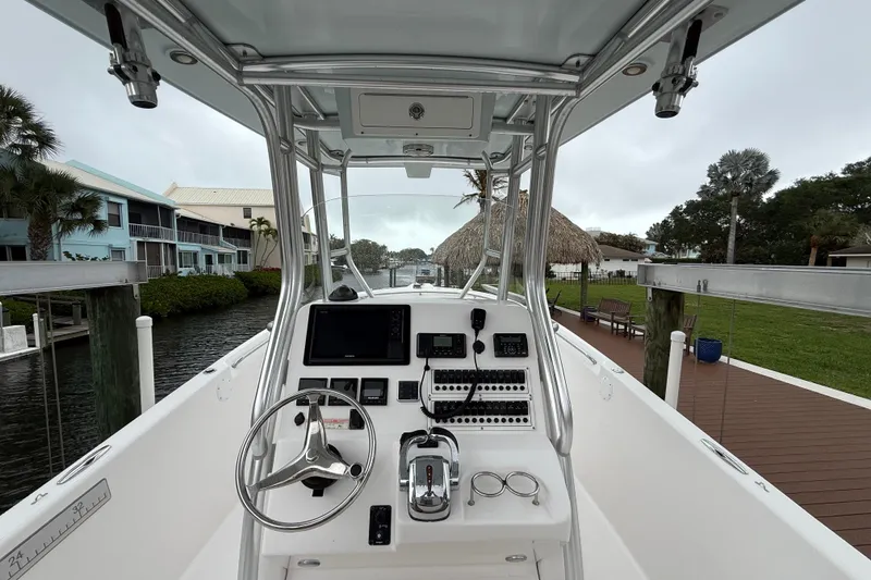Slide: The Image of 2017 Pro-Line 29 Grand Sport boat cockpit with steering wheel and control panel. - 3
