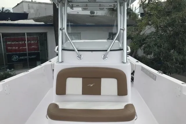 Slide: The Image of 2017 Pro-Line 29 Grand Sport boat with tan seating and center console. - 4