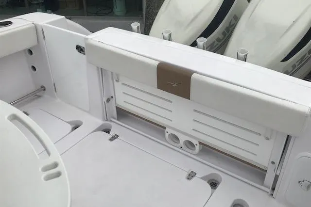 Slide: The Image of 2017 Pro-Line 29 Grand Sport boat interior with white seating and storage compartments. - 8