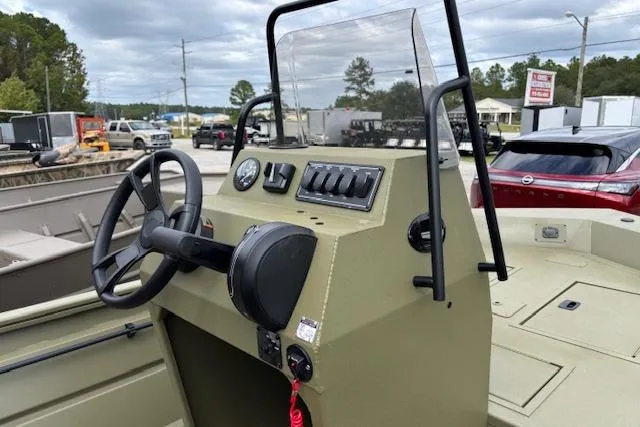 Slide: The Image of 2026 Lowe Roughneck 1760 Deluxe Tiller boat console with steering wheel and controls. - 6
