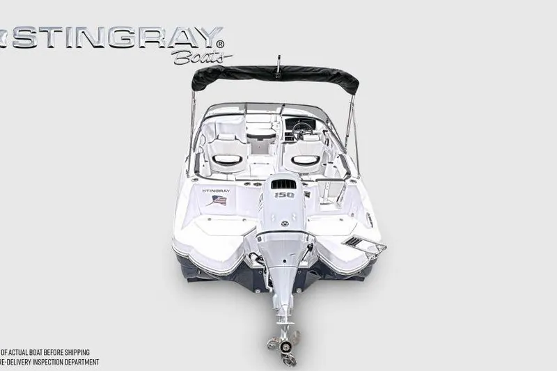 Slide: The Image of 2026 Stingray 211 DC boat with outboard motor, sleek design, and spacious seating. - 4