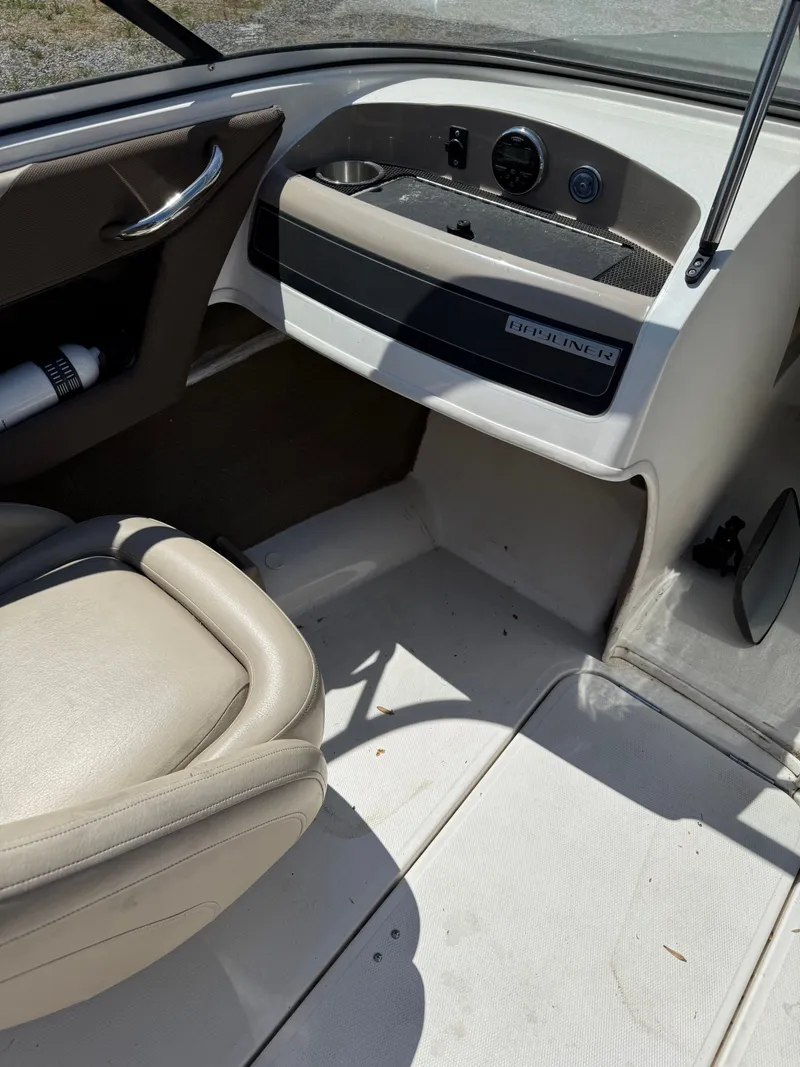 Slide: The Image of Interior of a 2015 Bayliner 185 boat with seat and dashboard. - 4