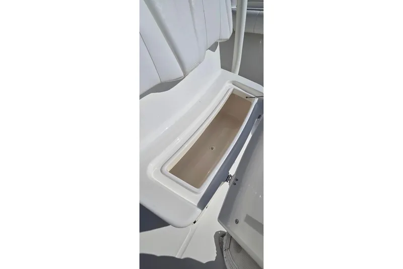Slide: The Image of 2014 Regulator 25 boat storage compartment with open lid. - 10