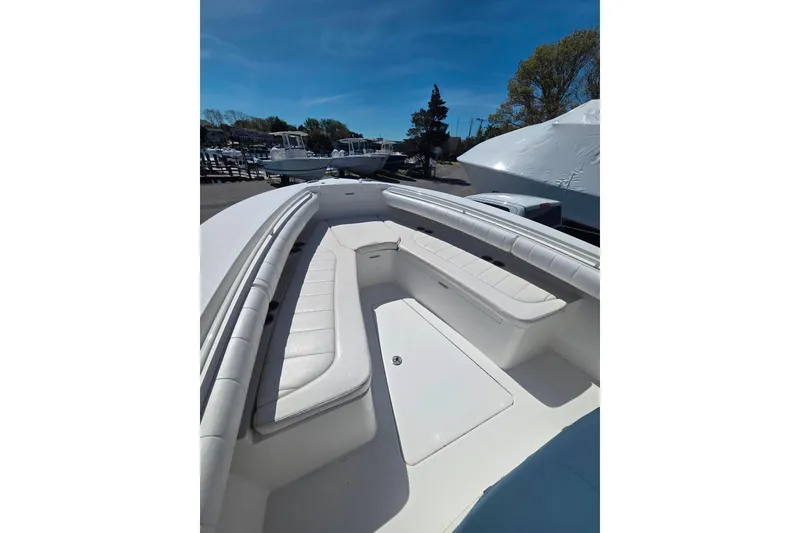 Slide: The Image of 2014 Regulator 25 boat with spacious seating and sleek design under clear blue sky. - 14