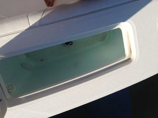 Slide: The Image of 2014 Regulator 25 boat with open storage compartment. - 15