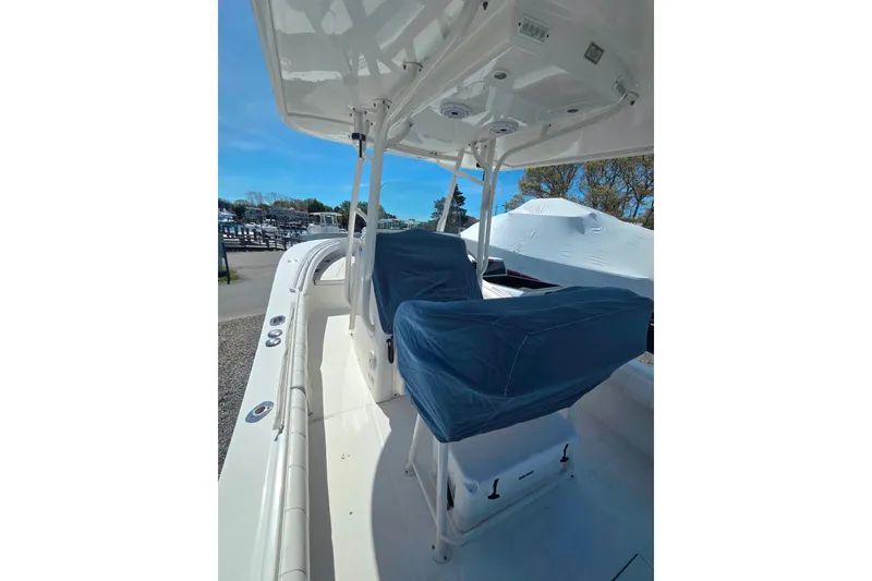 Slide: The Image of 2014 Regulator 25 boat interior with covered seats and overhead console. - 17