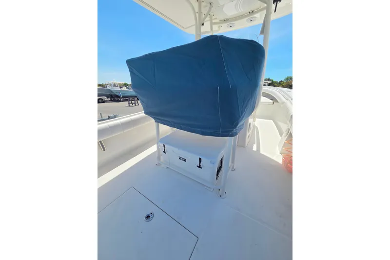 Slide: The Image of 2014 Regulator 25 boat interior with covered seating and storage compartment. - 18