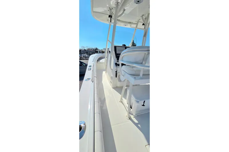 Slide: The Image of 2014 Regulator 25 boat interior with helm and seating, showcasing sleek design and functionality. - 20