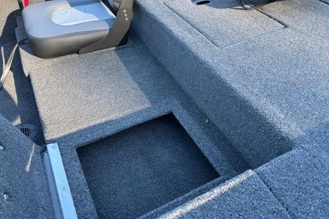 Slide: The Image of Interior of 2026 Lowe Skorpion 17 boat, featuring carpeted flooring and seating. - 2