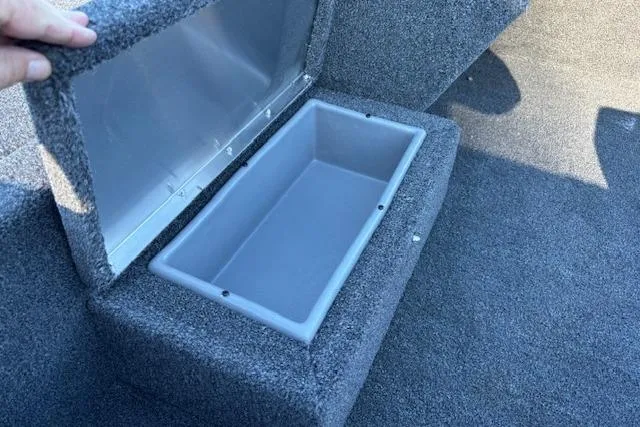 Slide: The Image of Open storage compartment in 2026 Lowe Skorpion 17 boat, featuring carpeted interior. - 4