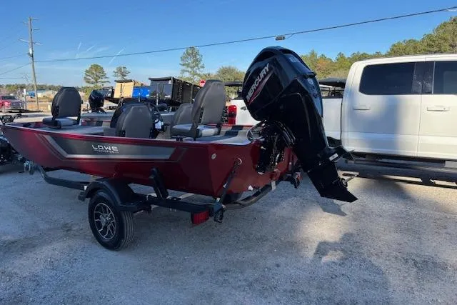 Slide: The Image of 2026 Lowe Skorpion 17 boat with Mercury engine, parked outdoors on a trailer. - 7