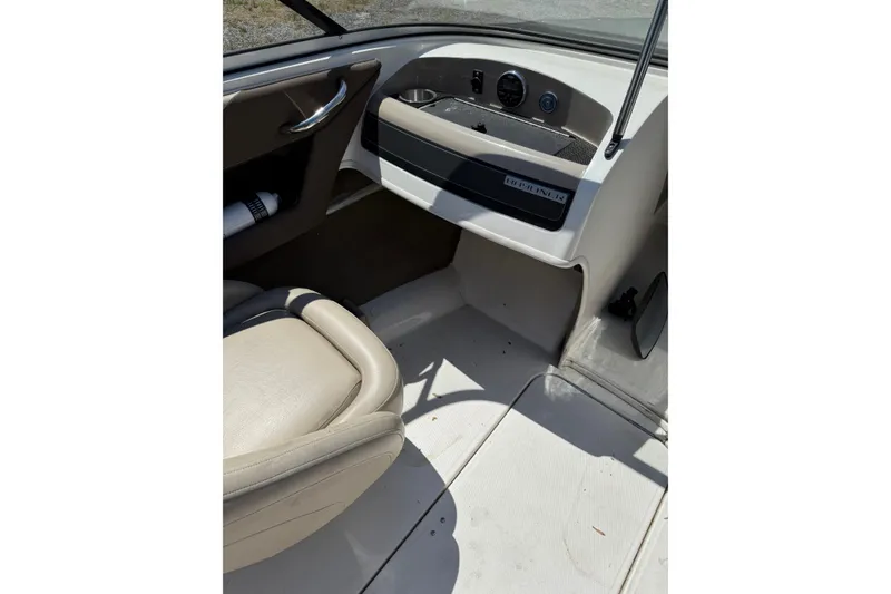 Slide: The Image of Interior view of 2015 Bayliner 185 Bowrider boat, featuring dashboard and seating area. - 5