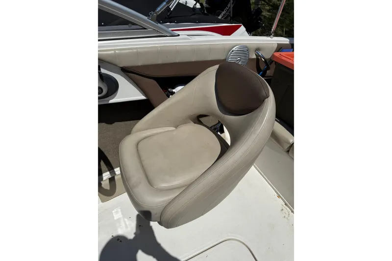Slide: The Image of 2015 Bayliner 185 Bowrider boat seat, beige upholstery, and sleek design. - 7