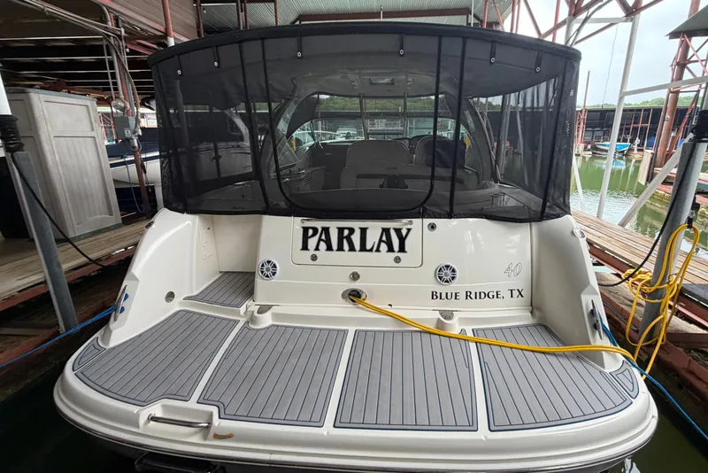 The Image of 2006 Sea Ray 40 Sundancer docked, rear view with "Parlay" name and Blue Ridge, TX location. - 0