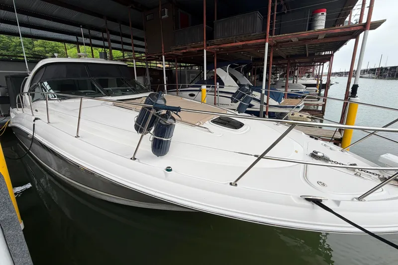 Slide: The Image of 2006 Sea Ray 40 Sundancer docked in a marina, featuring sleek white design and modern amenities. - 1