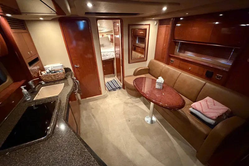 Slide: The Image of Luxurious interior of a 2006 Sea Ray 40 Sundancer yacht with elegant seating and kitchenette. - 12