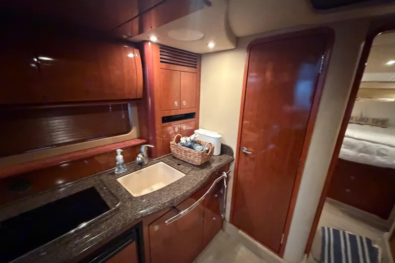 Slide: The Image of Luxurious 2006 Sea Ray 40 Sundancer yacht interior with elegant wood cabinetry and modern amenities. - 15