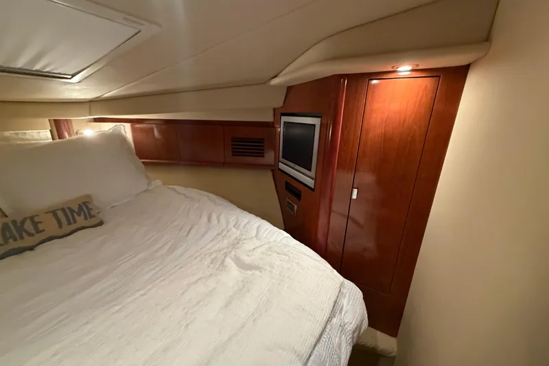 Slide: The Image of Cozy cabin interior of 2006 Sea Ray 40 Sundancer with bed and TV. - 17