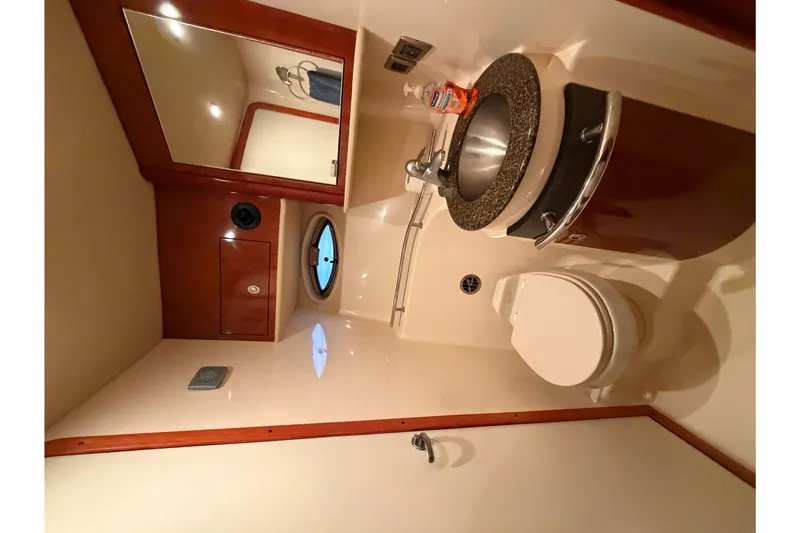 Slide: The Image of Luxurious bathroom in 2006 Sea Ray 40 Sundancer yacht with modern fixtures and porthole window. - 20