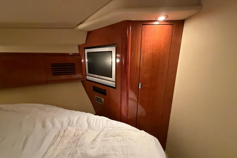 Slide: The Image of Interior of 2006 Sea Ray 40 Sundancer yacht with wood paneling and built-in TV. - 22