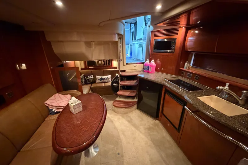 Slide: The Image of Luxurious 2006 Sea Ray 40 Sundancer yacht interior with kitchen and seating area. - 23