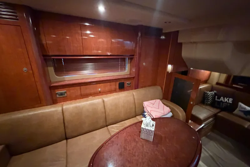 Slide: The Image of Interior of 2006 Sea Ray 40 Sundancer yacht with leather seating and wooden finishes. - 25