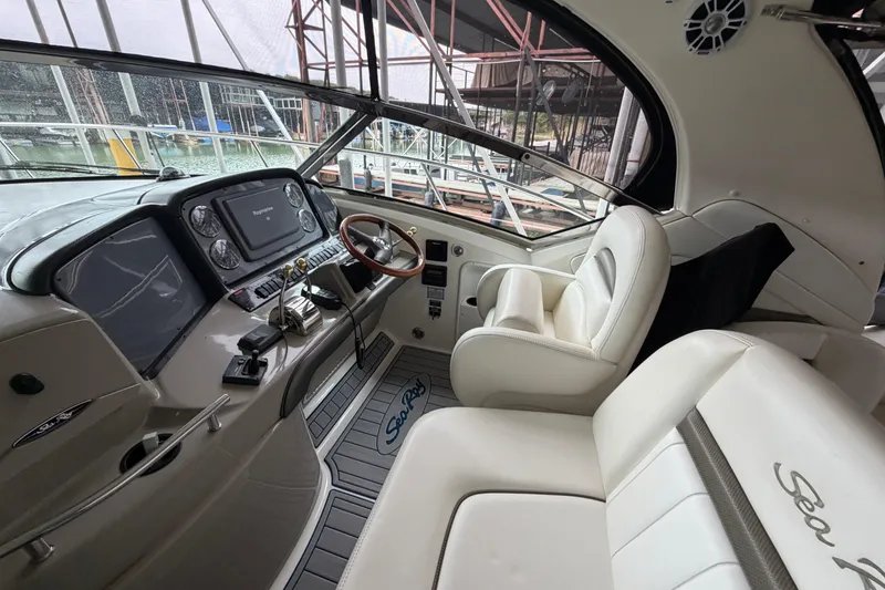 Slide: The Image of Interior of 2006 Sea Ray 40 Sundancer yacht with luxurious white seating and modern dashboard. - 3